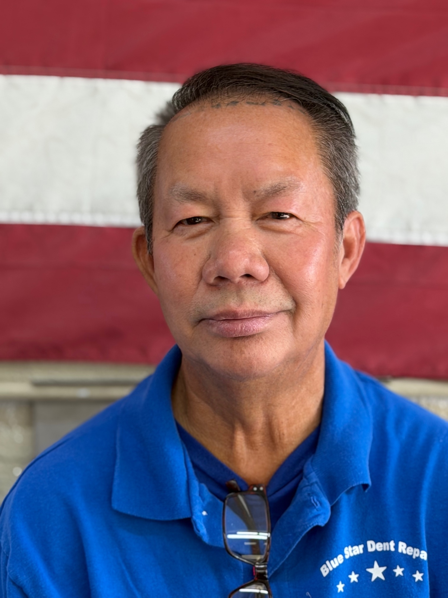 Blue Star Dent Repair family team member in a blue shop polo